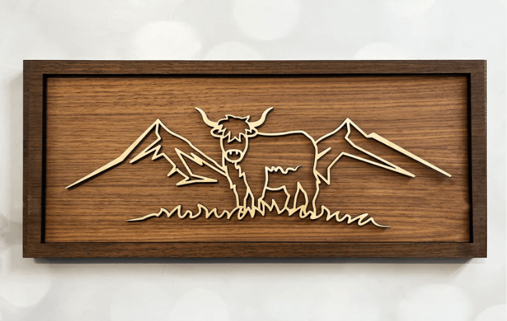 Highland Cow Line Art – minimalist wooden wall art handcrafted in New Zealand by Soul Etch, featuring a Highland cow and mountains on a walnut background.